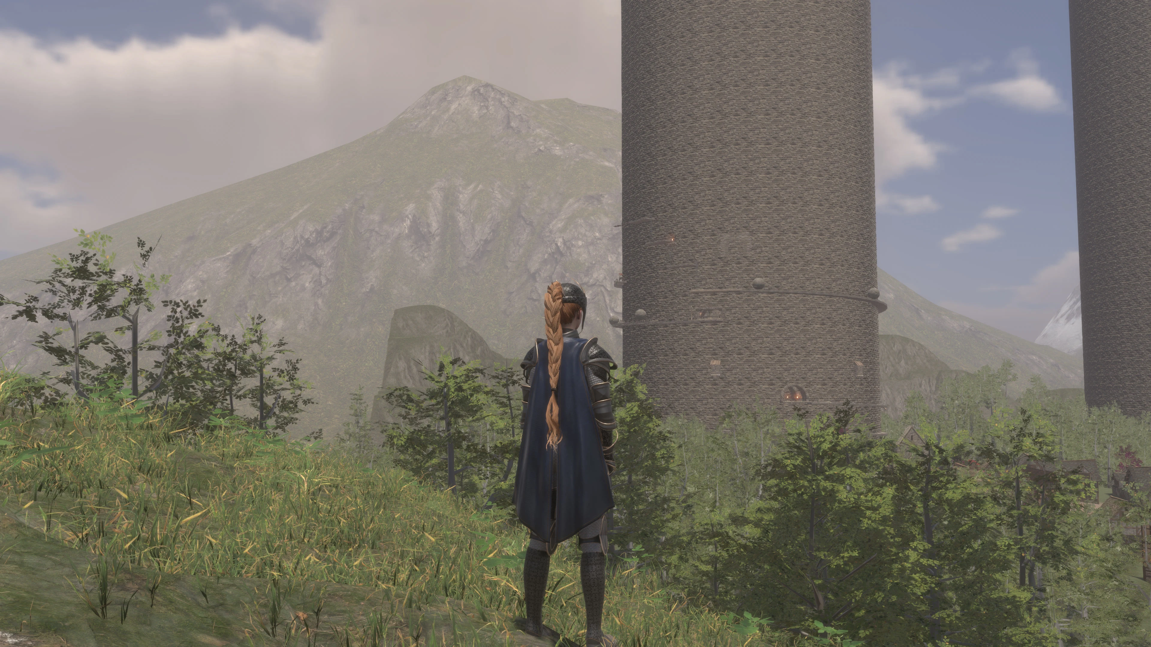 An adventurer facing the towers, in the mountains